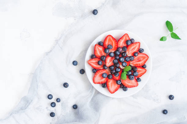 istock Fruit salad with strawberry and blueberry. Flat lay, top view 808105652