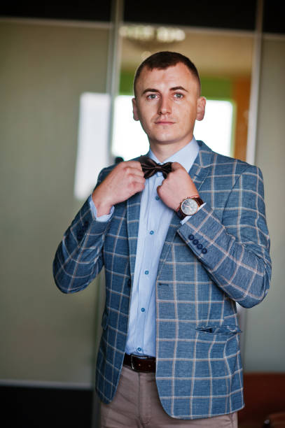 istock Very handsome groom posing in his room. 808131060