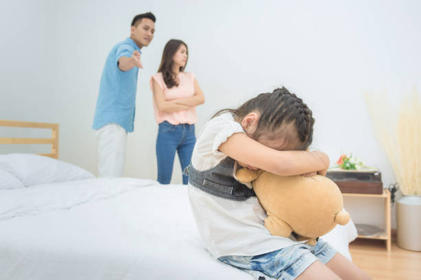 Asian little girl sadness while parent quarrelling in bedroom. Asian little girl sadness while parent quarrelling in bedroom.Photo design for family problems and unhappy concept. asian baby crying while mother scolding stock pictures, royalty-free photos & images