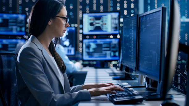 istock Female Engineer Controller Observes Working of the System. In the Background People Working and Monitors Show Various Information. 808157306