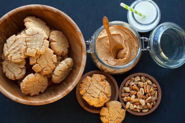 Peanut butter cookies with milk on a black background, selective focus stock photo