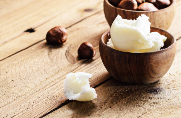 istock Shea butter and nuts on a wooden board, copy space. 808204214