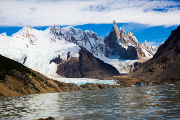 Lake at foot of Fitz Roy, Cerro Torre, Andes Mountain lake at foot of Cerro Torre and Fitz Roy on sunny day, Santa Cruz, Argentina, South America foothills parkway photos stock pictures, royalty-free photos & images
