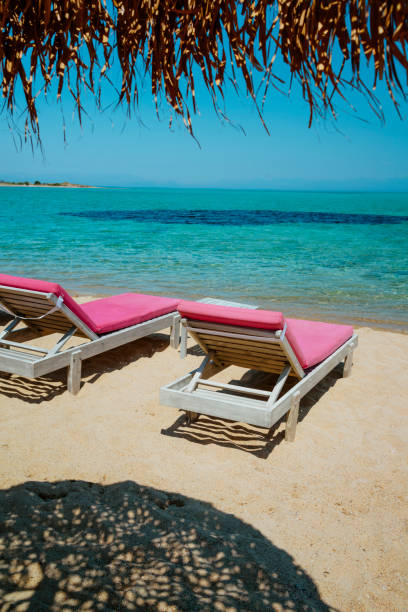 istock Beach chairs with umbrella and beautiful sand beach 808211268