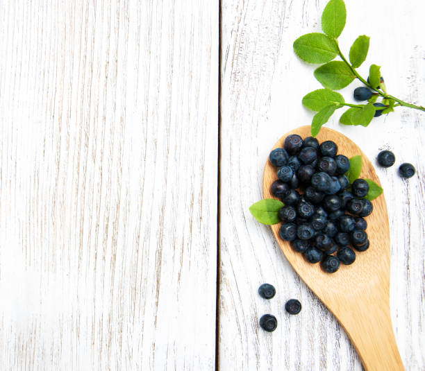 istock Blueberries on a old wooden background 808218914
