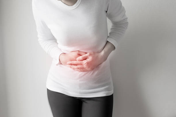 istock Woman stomachache on gray wall background. 808239548