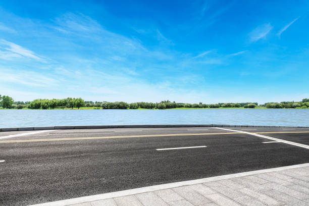 istock Asphalt road and sky cloud landscape by the lake 808260038