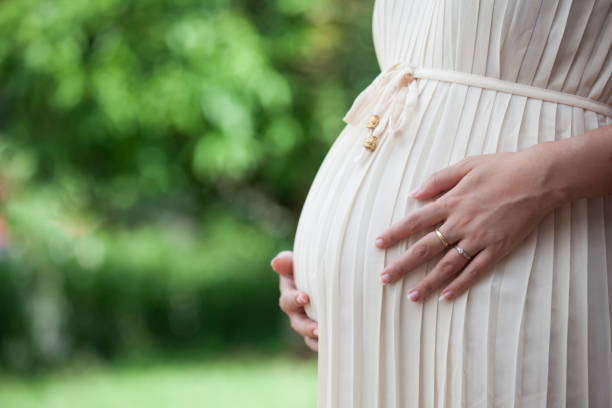 istock Pregnant woman touching her big belly 808275574