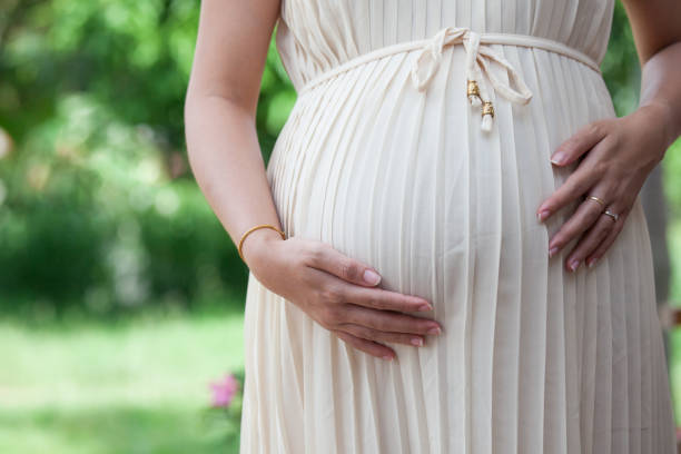 istock Pregnant woman touching her big belly 808275586