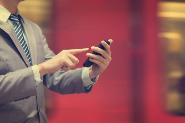 istock Businessman using smartphone at train station. 808307474