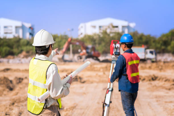 Construction engineer with foreman worker checking construction site for new Infrastructure construction project Construction engineer with foreman worker checking construction site for new Infrastructure construction project. photo concept for engineering work. theodolite photos stock pictures, royalty-free photos & images