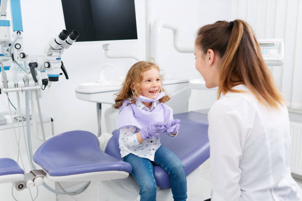 istock Little girl playing with dentist 808333094