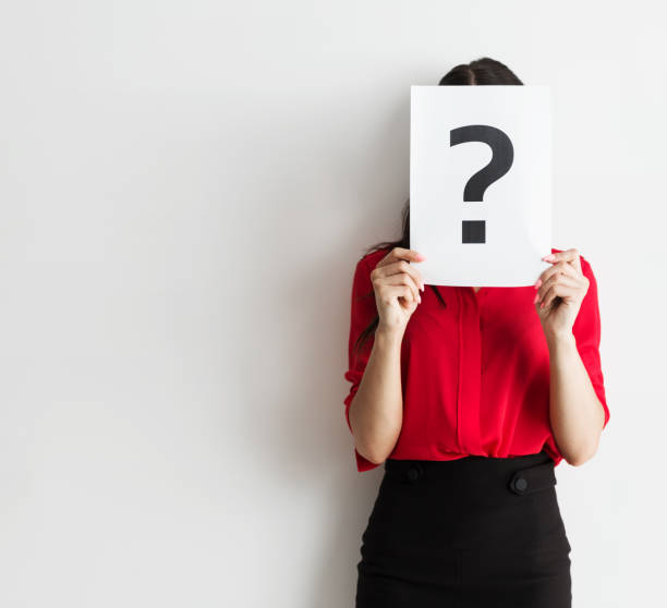 istock Businesswoman holding a question mark 808336782