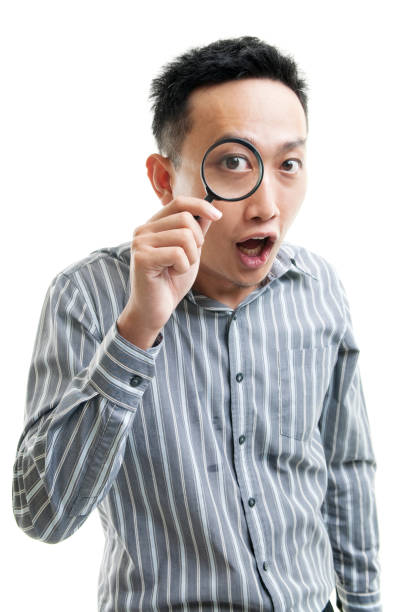 istock Asian businessman holding magnifier glass 808350116