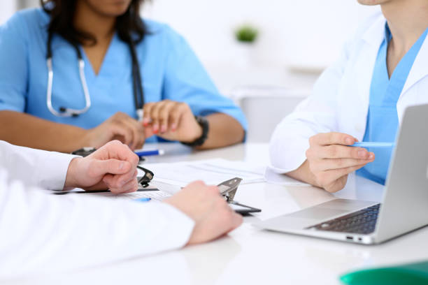 istock Group of doctors discuss at meeting 808356414