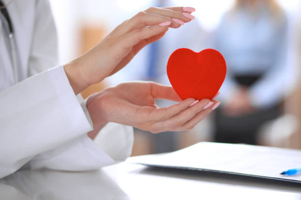 istock Female doctor with stethoscope holding heart. 808369512