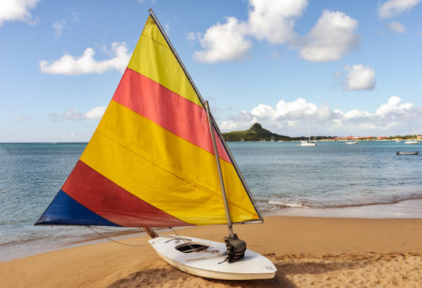 istock Colorful single sailboat on tropical sandy beach 808385022