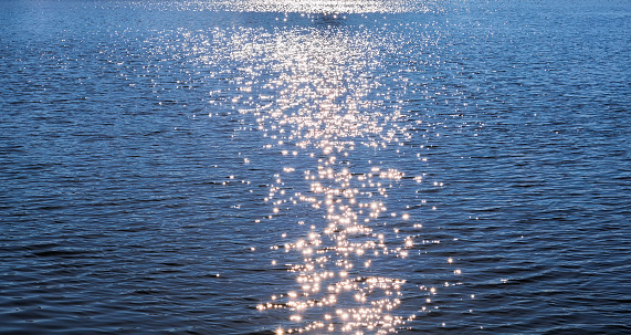 Blue water surface with Sun Stars effect background