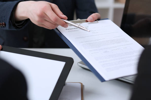 istock Male arm in suit offer contract form on clipboard pad 808396106