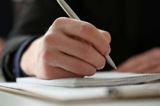 istock Male hand holding silver pen 808398180