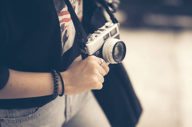 Young hipster woman hand holding retro camera close-up