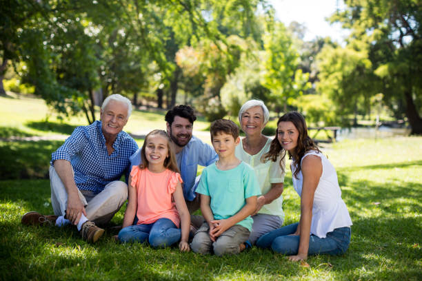 istock Multi generation family sitting in park 808405730