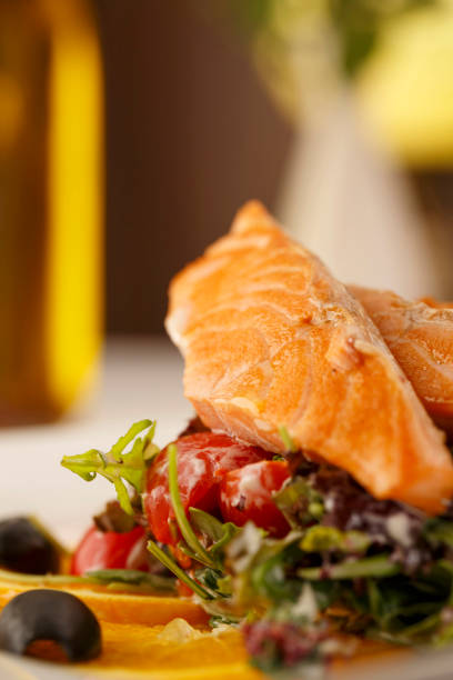 istock Salmon with vegetables arranged on a plate, Traditional dish in elegant setting, Selective focus with soft light 808410096