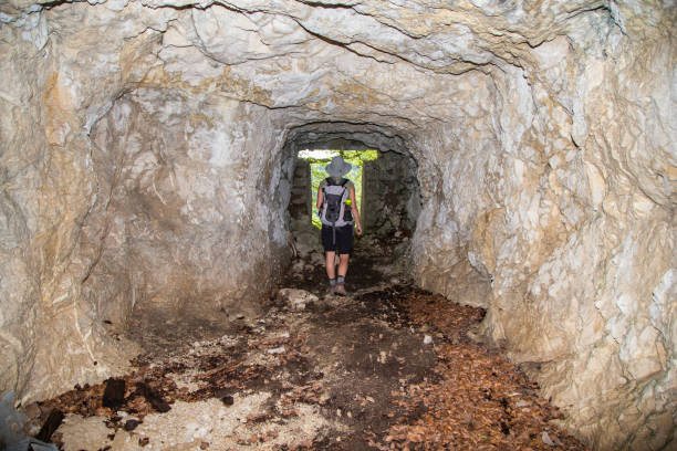 istock Adult hiker explores the World War one cavern - cave 808410910