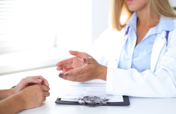 istock Doctor and patient are discussing something, just hands at the table 808414474
