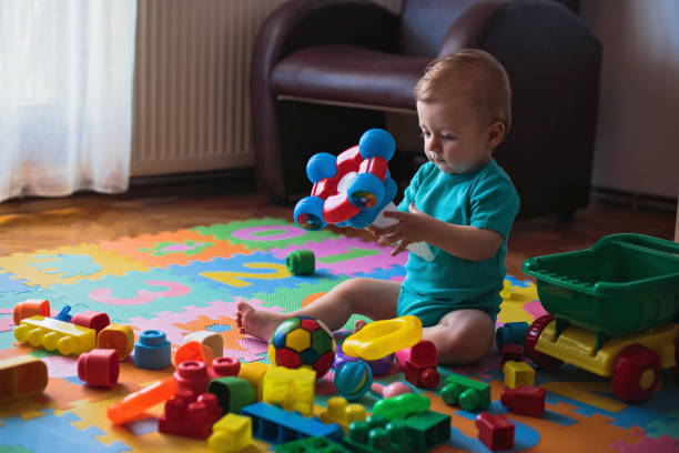 istock Baby boy playing with toys 808424962