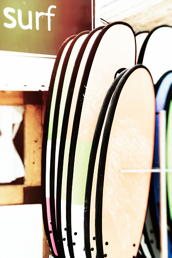 Surfboards displayed for sale or rent on the beach of El Palmar, Spain