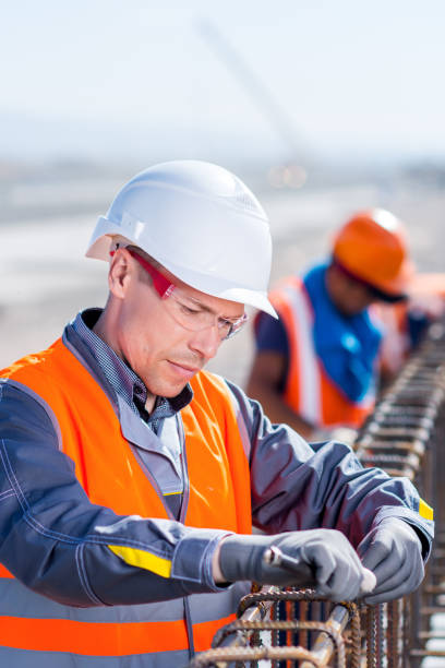 istock worker fixing steel rebar at building site 808427386
