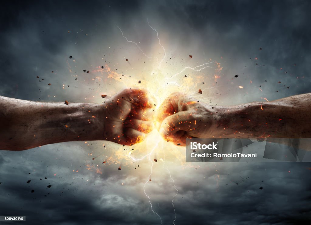 Conflict Concept - Two Fists In Impact Two Fiery Fists In Impact With Stormy Sky In Background Strength Stock Photo