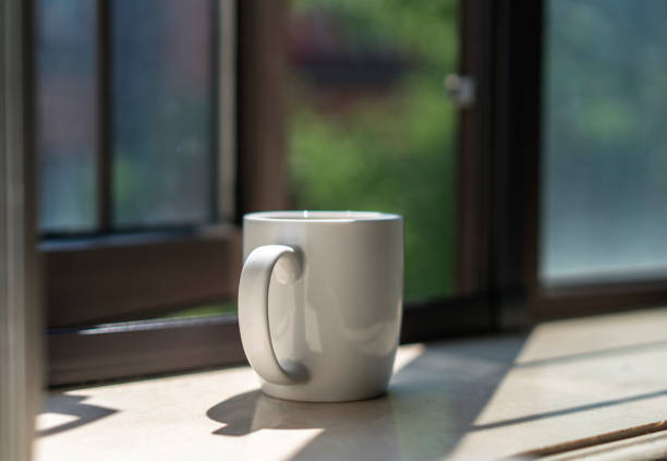 istock coffee cup on window sill in the morning 808452802