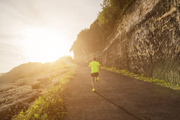 istock Jogging / running up the hill at sunset / sunrise. 808498824