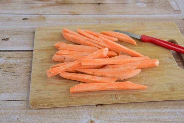istock Cutting of raw sweet potato 808502016