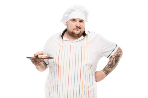 istock portrait of grimace chef holding plate with doughnuts isolated on white 808512204