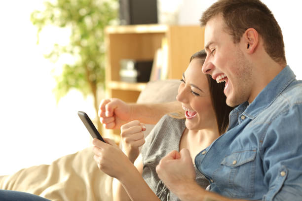 istock Excited couple checking content in a phone 808522502