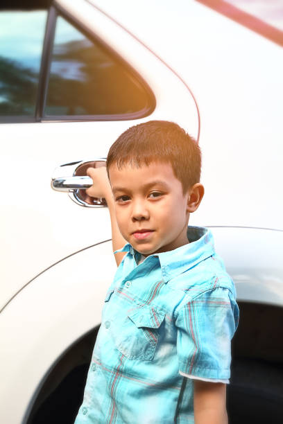 istock Young boy opening the car door 808530044