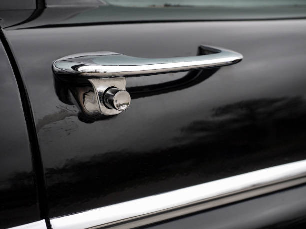 istock Beautiful chrome door handle on an old black car 808530310