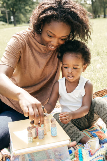 istock Playing outside the house with mom and dolls 808552684