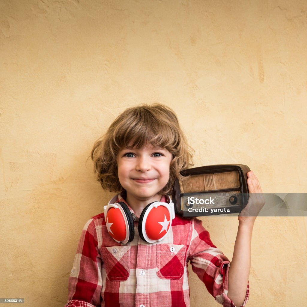 Retro music concept Kid listen music at home. Hipster child with retro vintage radio Arts Culture and Entertainment Stock Photo