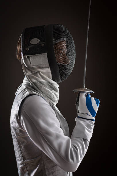 istock Fencer with Mask holding the sword in front of her 808556168