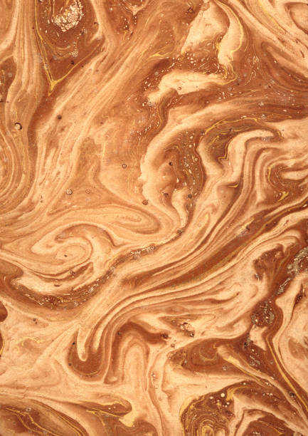 Ocher coloured Victorian Marbled Paper, 19th Century. Paper marbling is a method of aqueous surface design, which can produce patterns similar to smooth marble or other kinds of stone.