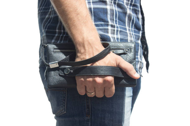 istock A guy in jeans and a shirt with a purse on his hand, Isolate 808565644