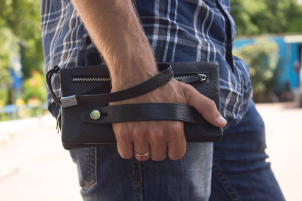 istock A guy in jeans and a shirt with a purse on his hand 808565698