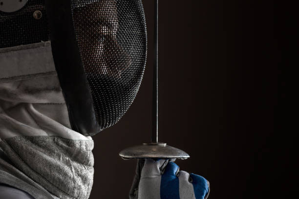 istock Fencer with Mask holding the sword in front of her 808568696