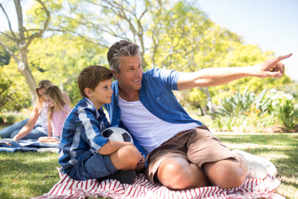 istock Father and son looking at the distance in park 808577456