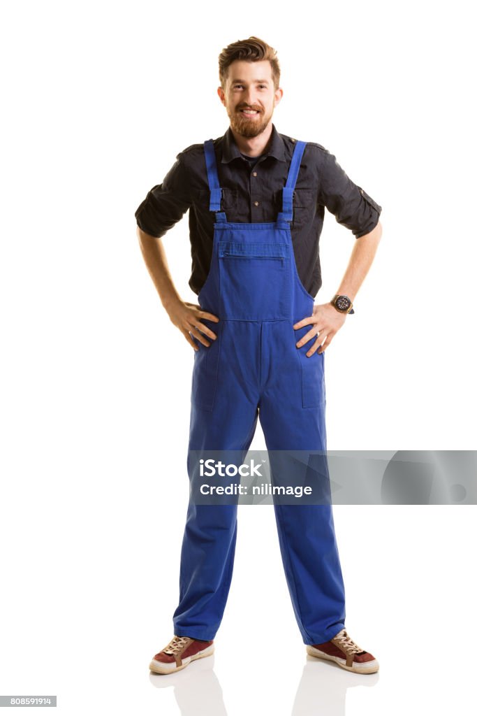 Young repairman posing on white background Coveralls Stock Photo