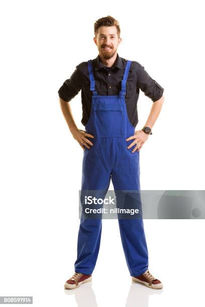 Young Repairman Posing On White Background Stock Photo - Download Image Now - Coveralls, Men, Cut Out